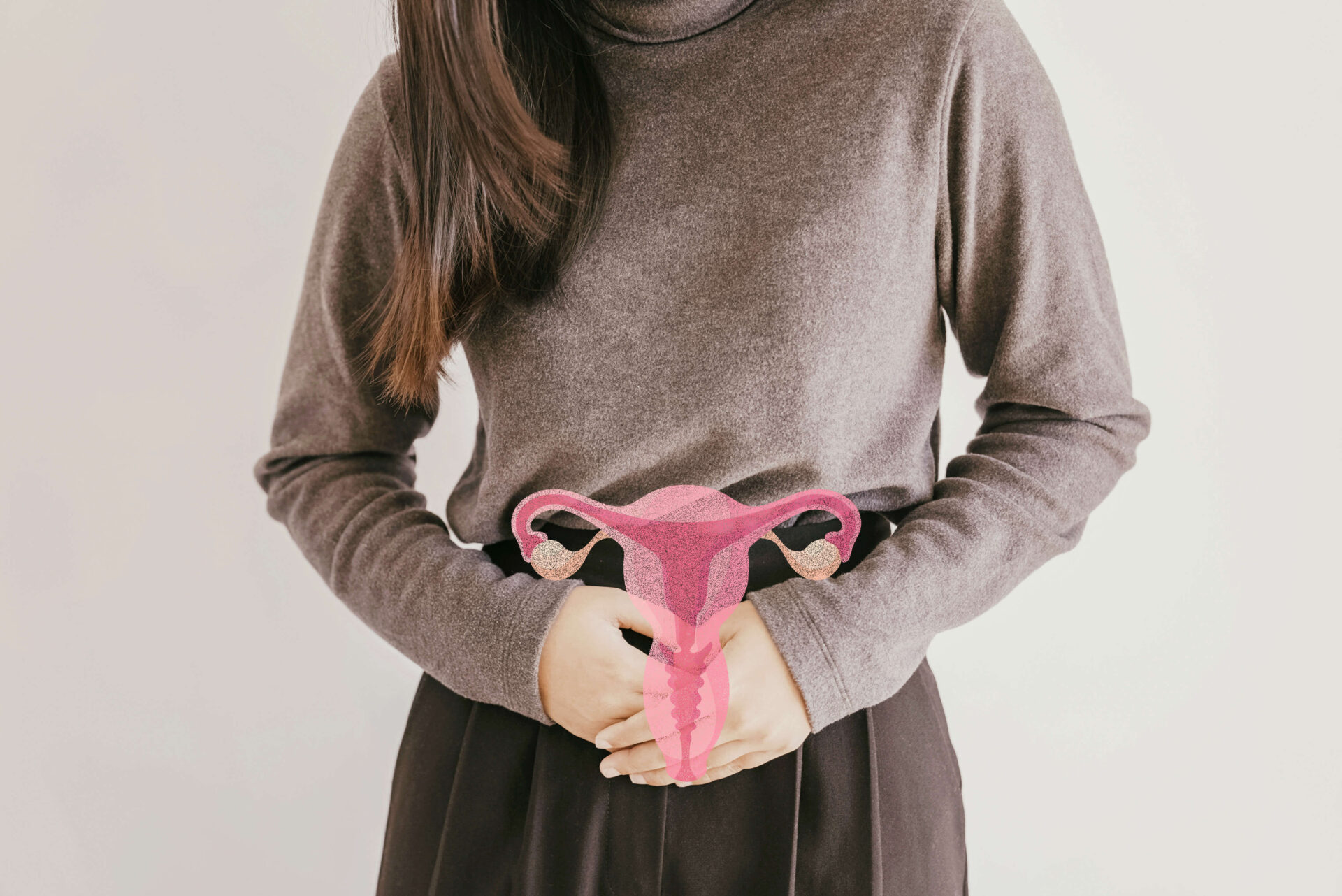 Woman holding abdomen with pink uterus illustration representing PCOS endometriosis and adenomyosis conditions affecting fertility