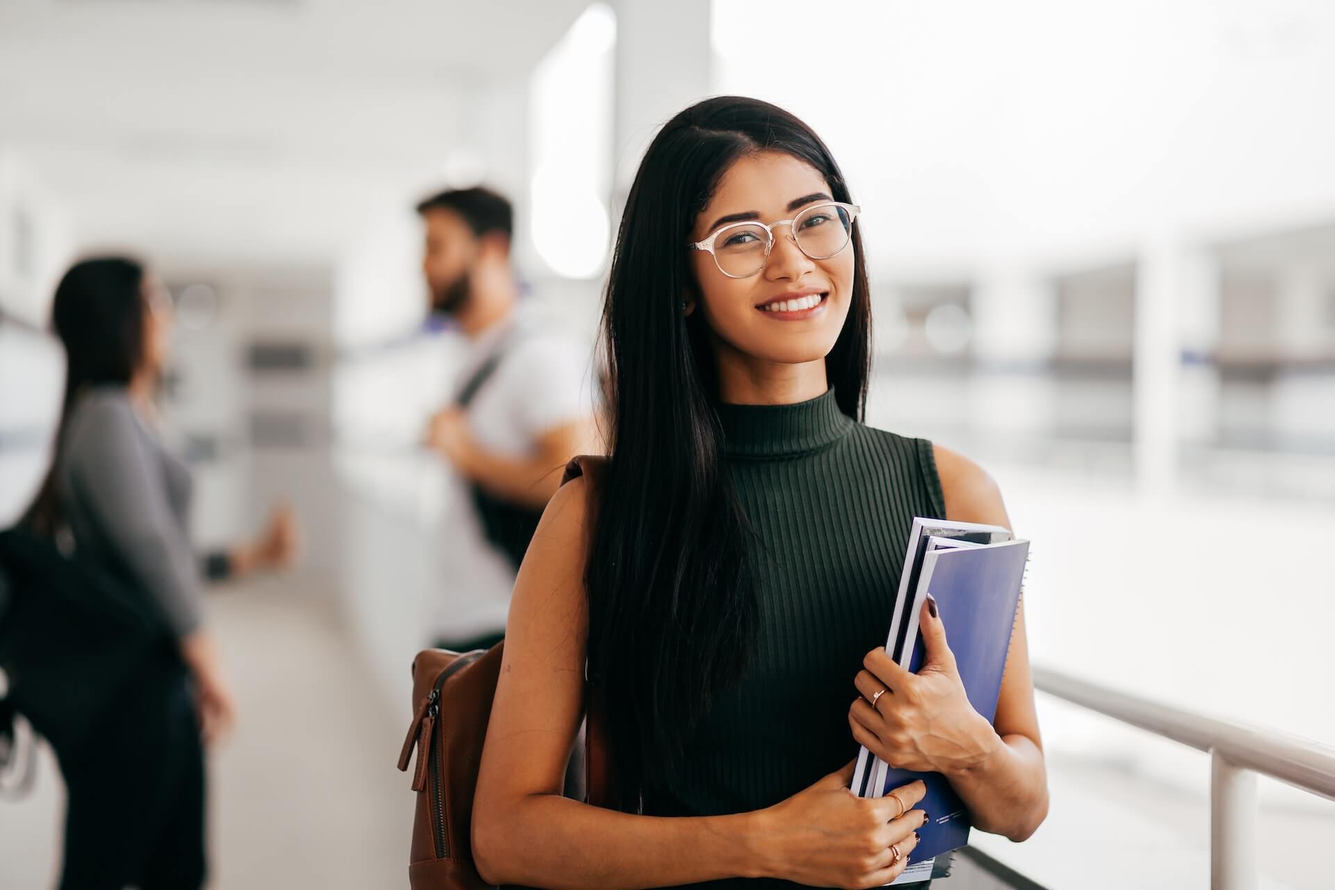 Confident young woman with books and backpack representing women who choose to become egg donors to help others build familie