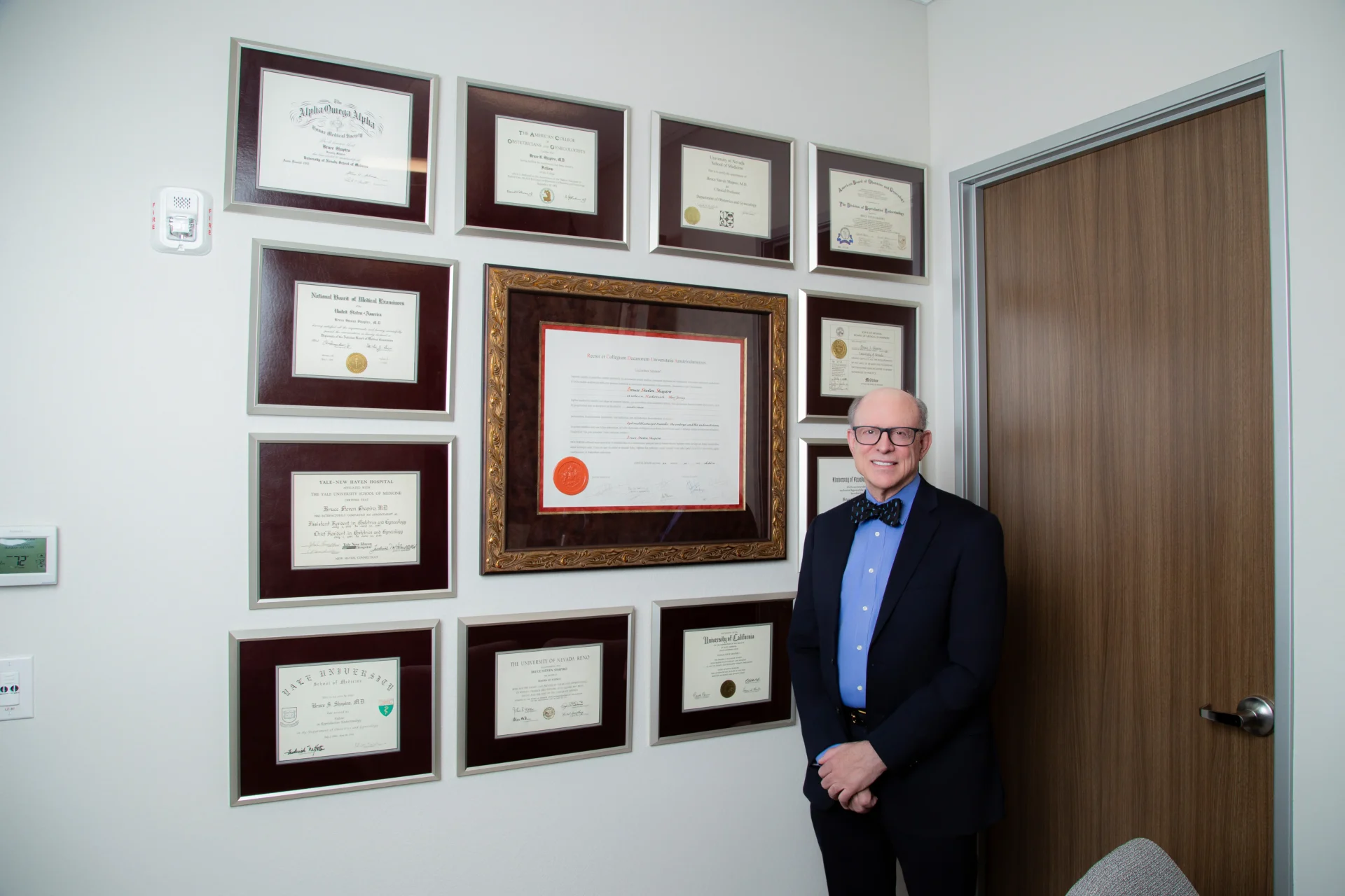Dr. Bruce Shapiro MD PhD founder of The Fertility Center of Las Vegas standing before his credentials recognized for influential fertility research