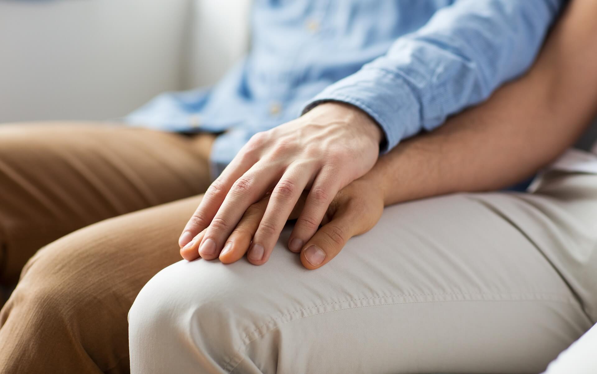 Couple holding hands offering emotional support during infertility treatment journey