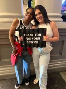 Two FCLV team members holding a Las Vegas Aces Thank You for Your Service sign at Nurses Night Out